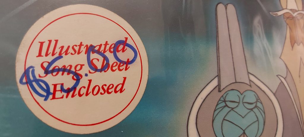 Sticker on Cosmic Christmas album indicating Song Sheet Enclosed.